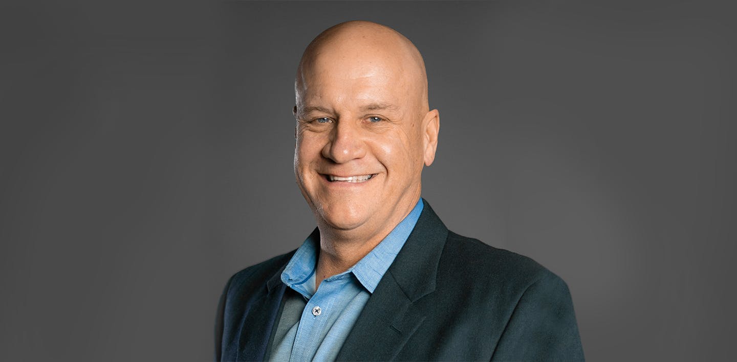 Wayne Fredrick against a gray backdrop