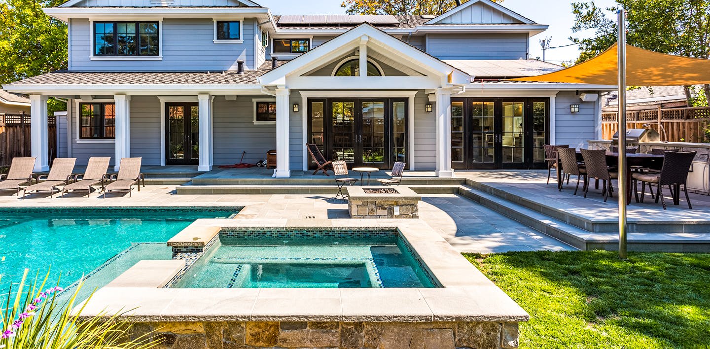 The back of a house with a pool and patio