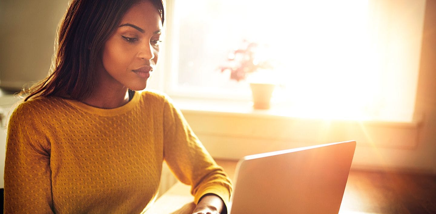 A woman works on a laptop