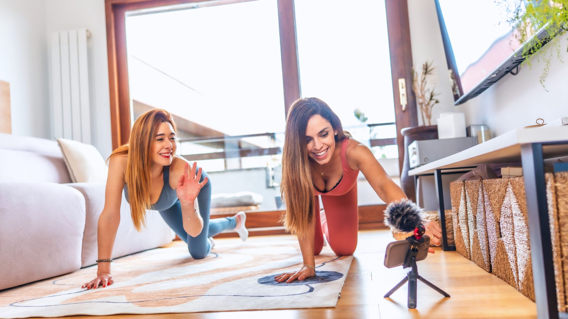 Two women in the living room working out and talking abouy How to Choose a Home That Fits their Lifestyle