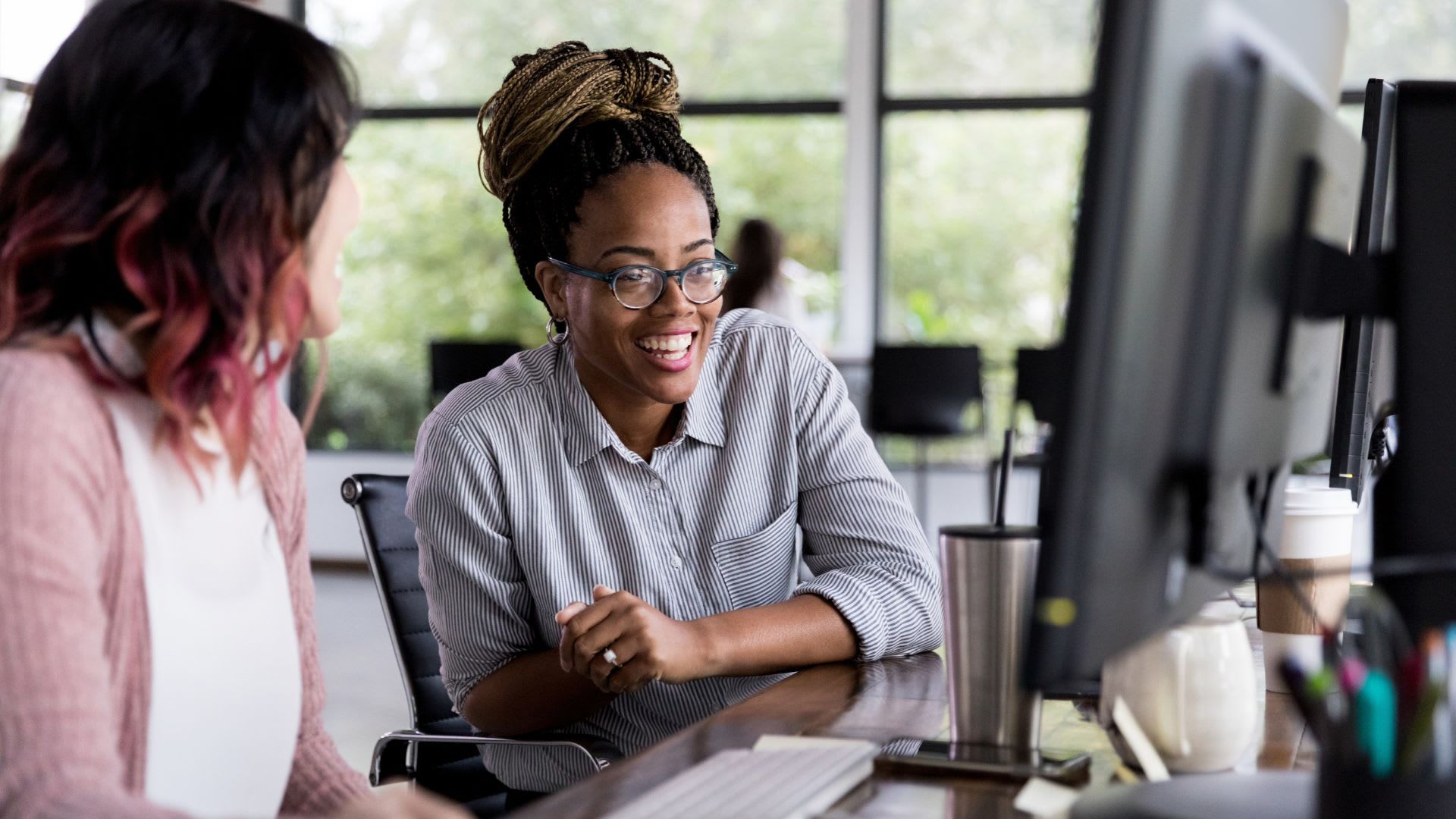 A women and a specialist in front a computer talking Provincial First-Time Homebuyer Incentives