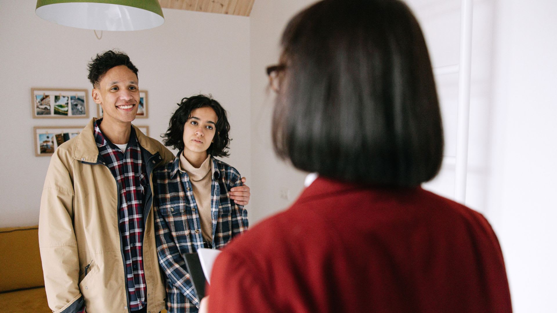 A professional advisor talking to a male and female advisor about What Fees Are Involved in Selling a House in Canada