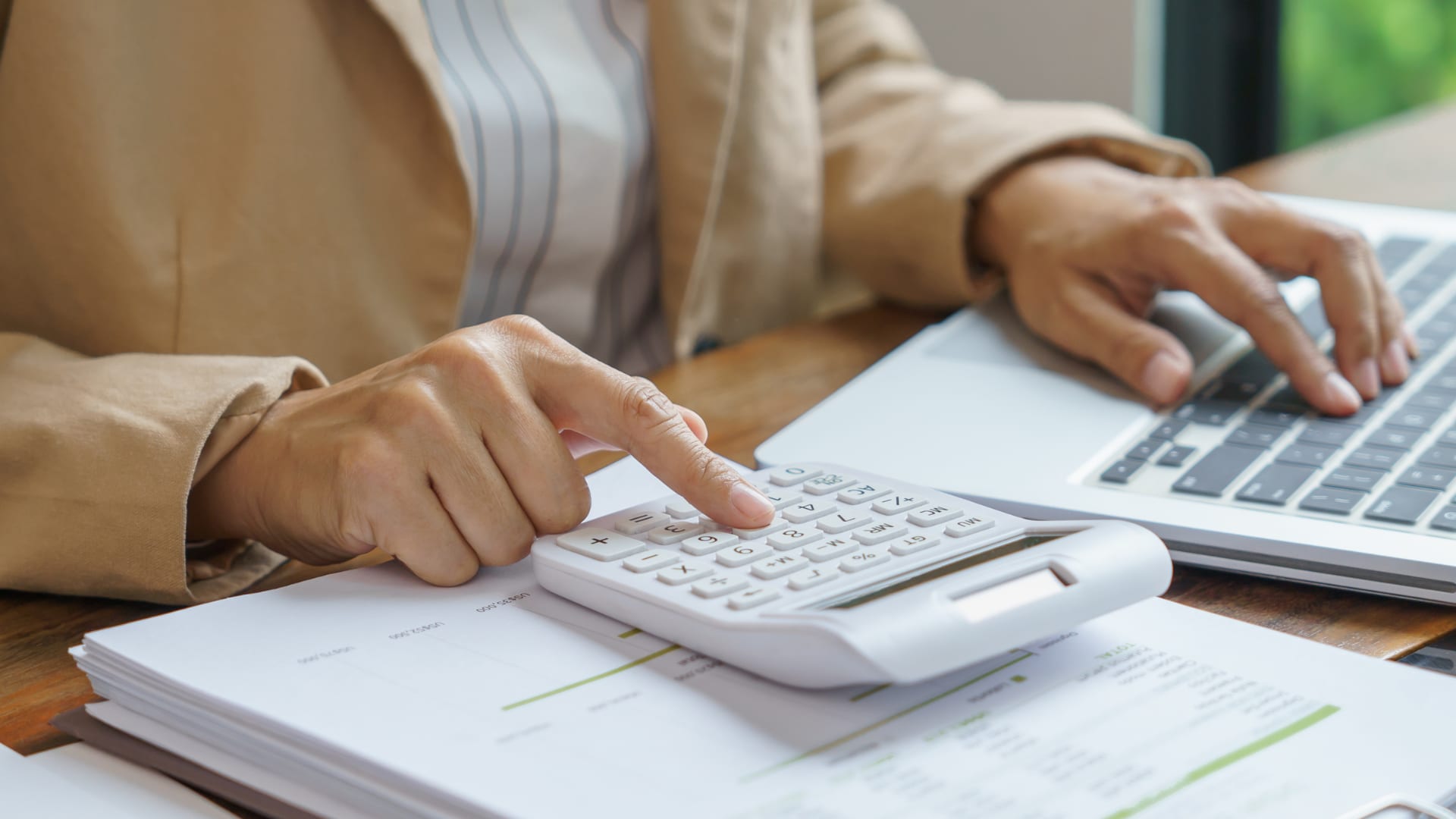 Renting vs. Buying The Core Financial Considerations A person calculating Renting vs. Buying The Core Financial Considerations