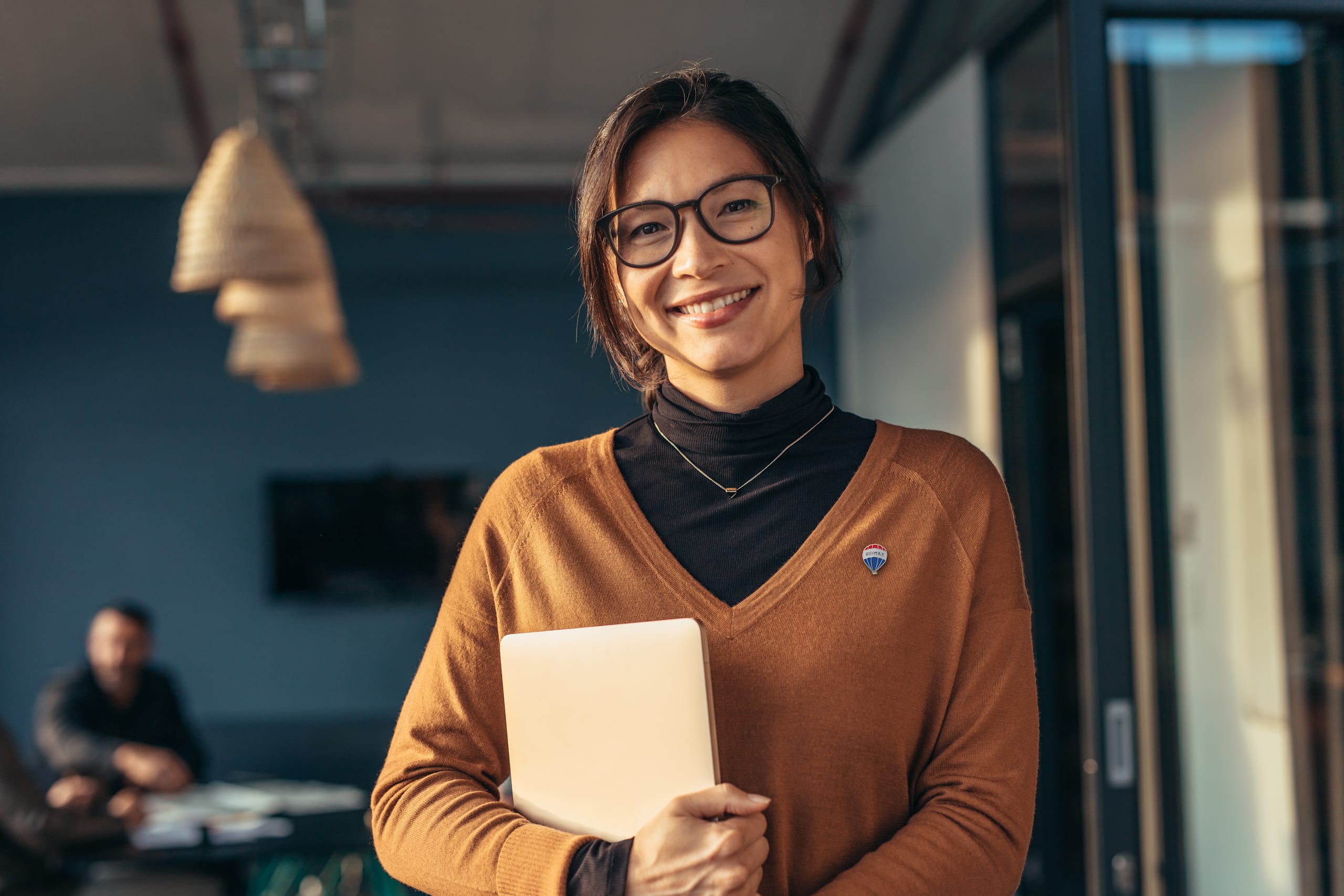 Portrait,Of,Happy,Business,Woman,Holding,A,Laptop,Standing,In