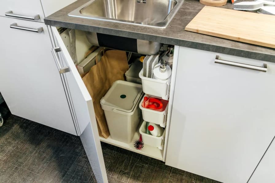 When under-the-sink storage is organized so dish pods and trash