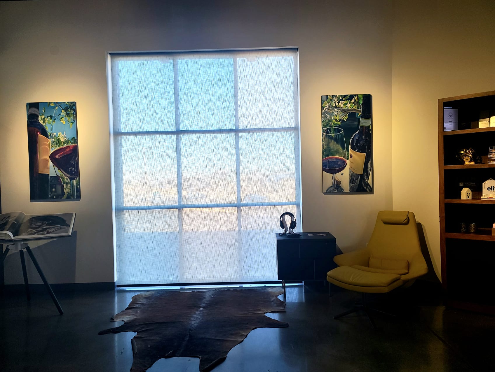 Two Art pieces hang next to windows