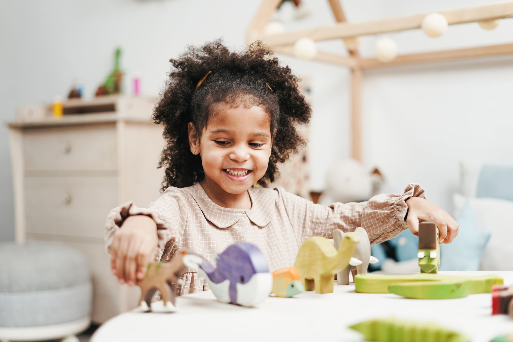 AST-young-girl-playing-with-toys-in-her-room - Wisconsin Early Autism  Project (WEAP)