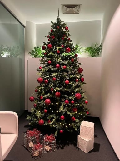A decorated christmas tree in an office cubicle