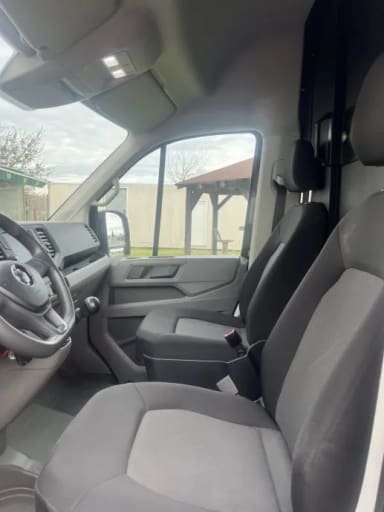 The interior of a vehicle with the driver's seat up