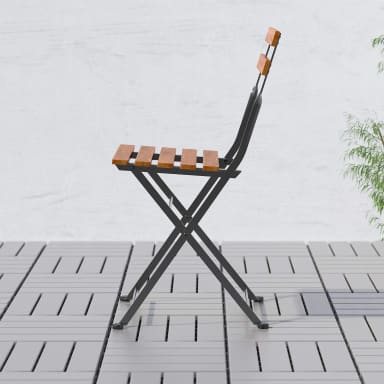 A folding chair sitting on top of a tiled floor