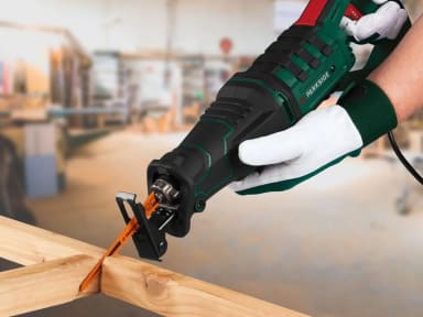 A person using a power tool on a piece of wood