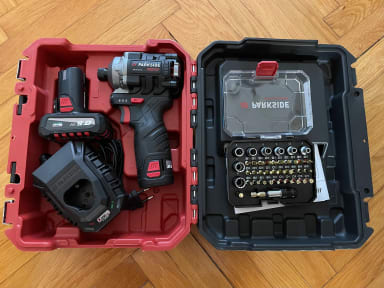 A tool box filled with tools on top of a wooden floor