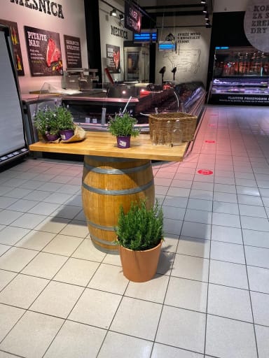 A large wooden barrel sitting on top of a tiled floor