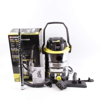 A yellow and black vacuum is next to a tool