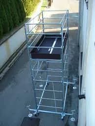 A metal structure with a black tray on top of it