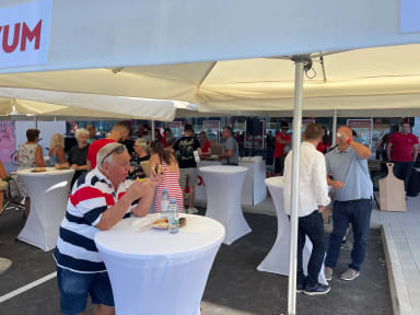 A group of people standing under a tent