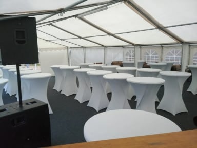 A large tent with tables and chairs in it