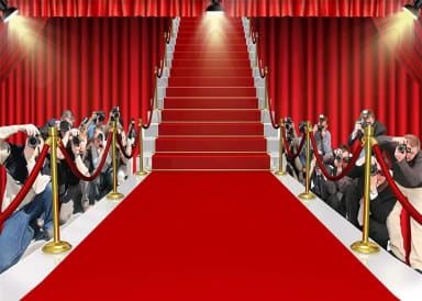A red carpeted stage with a red carpeted staircase leading up to a red