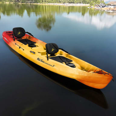 A yellow and red kayak floating on top of a lake