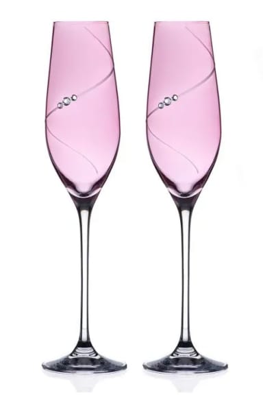A pair of wine glasses sitting next to each other