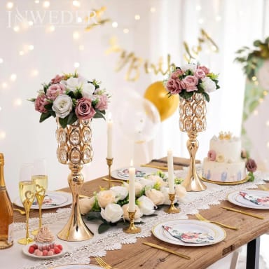 A table topped with plates and vases filled with flowers
