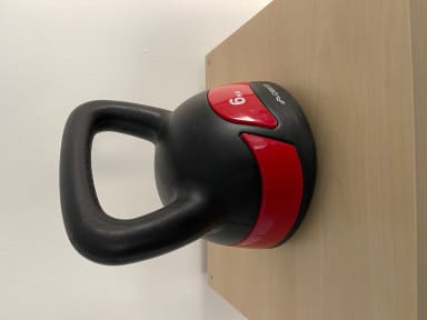 A close up of a black and red cup on a wall