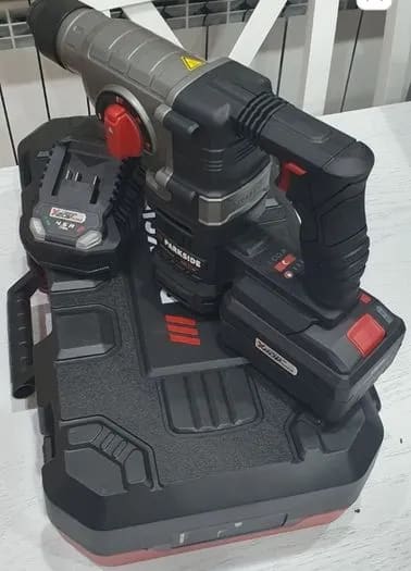 A cordless drill and power tool on a table
