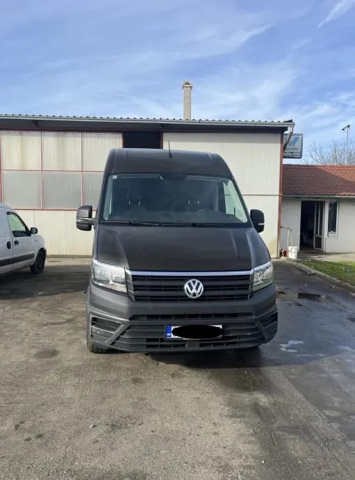 A van parked in front of a building