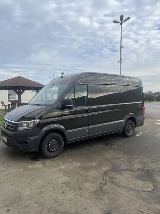 A black van parked in a parking lot