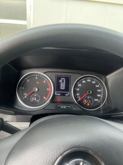 The dashboard of a car with a speedometer and gauges
