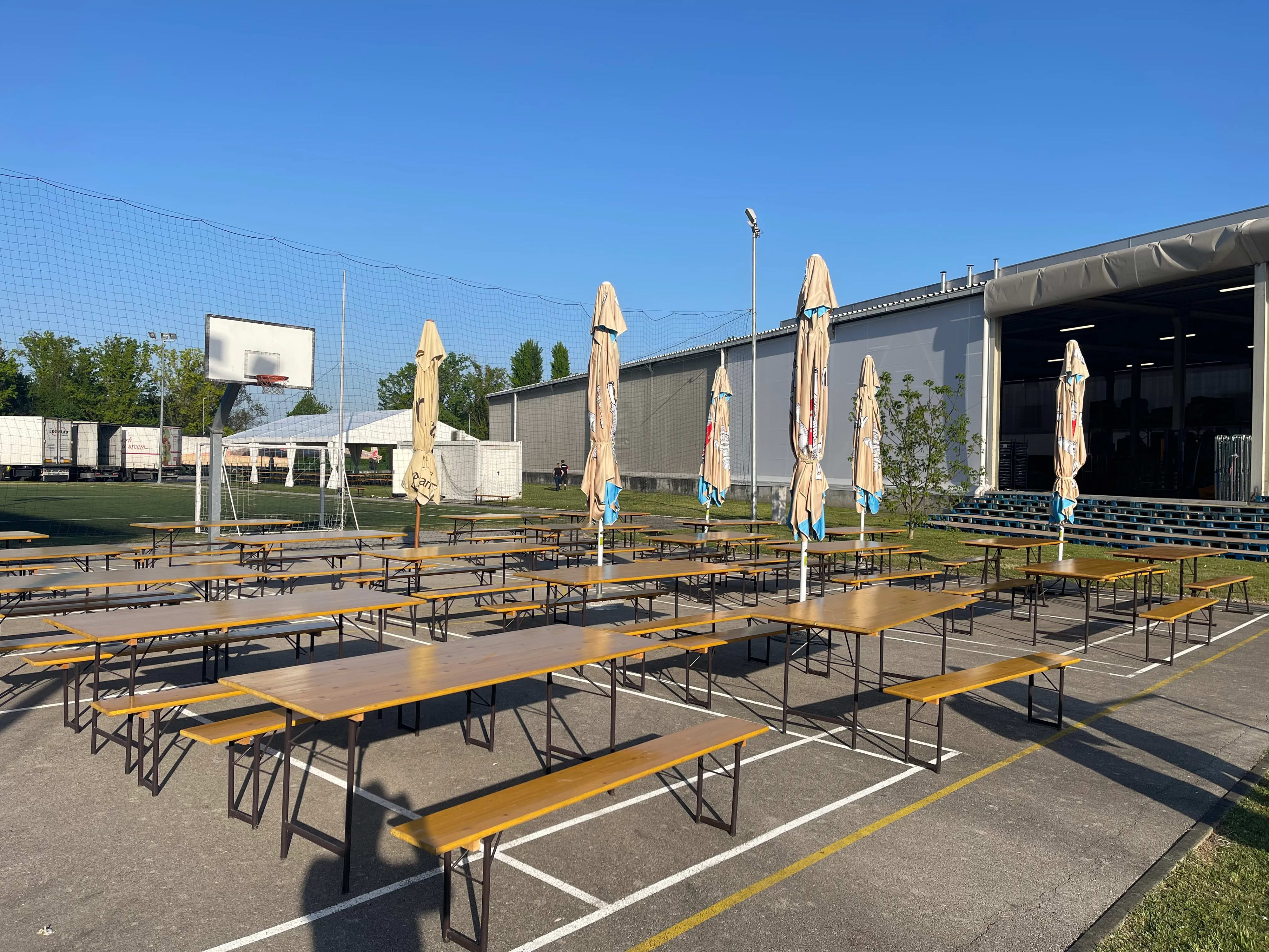 A row of tables with umbrellas on top of them