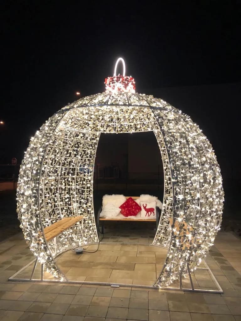 A bed covered in christmas lights in a room