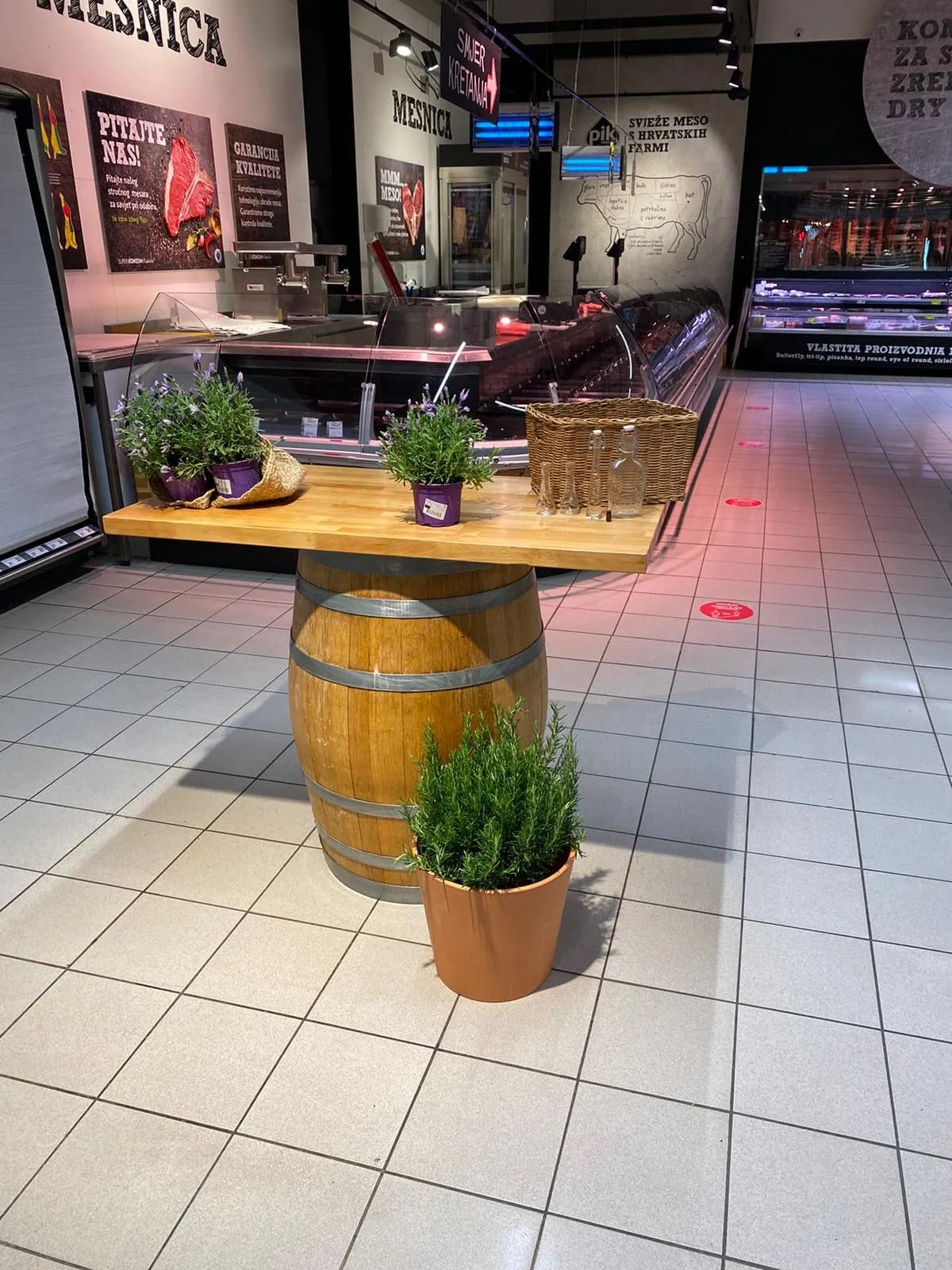 A large wooden barrel sitting on top of a tiled floor