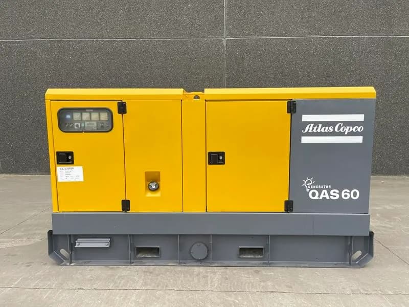 A yellow and gray machine sitting on top of a cement floor