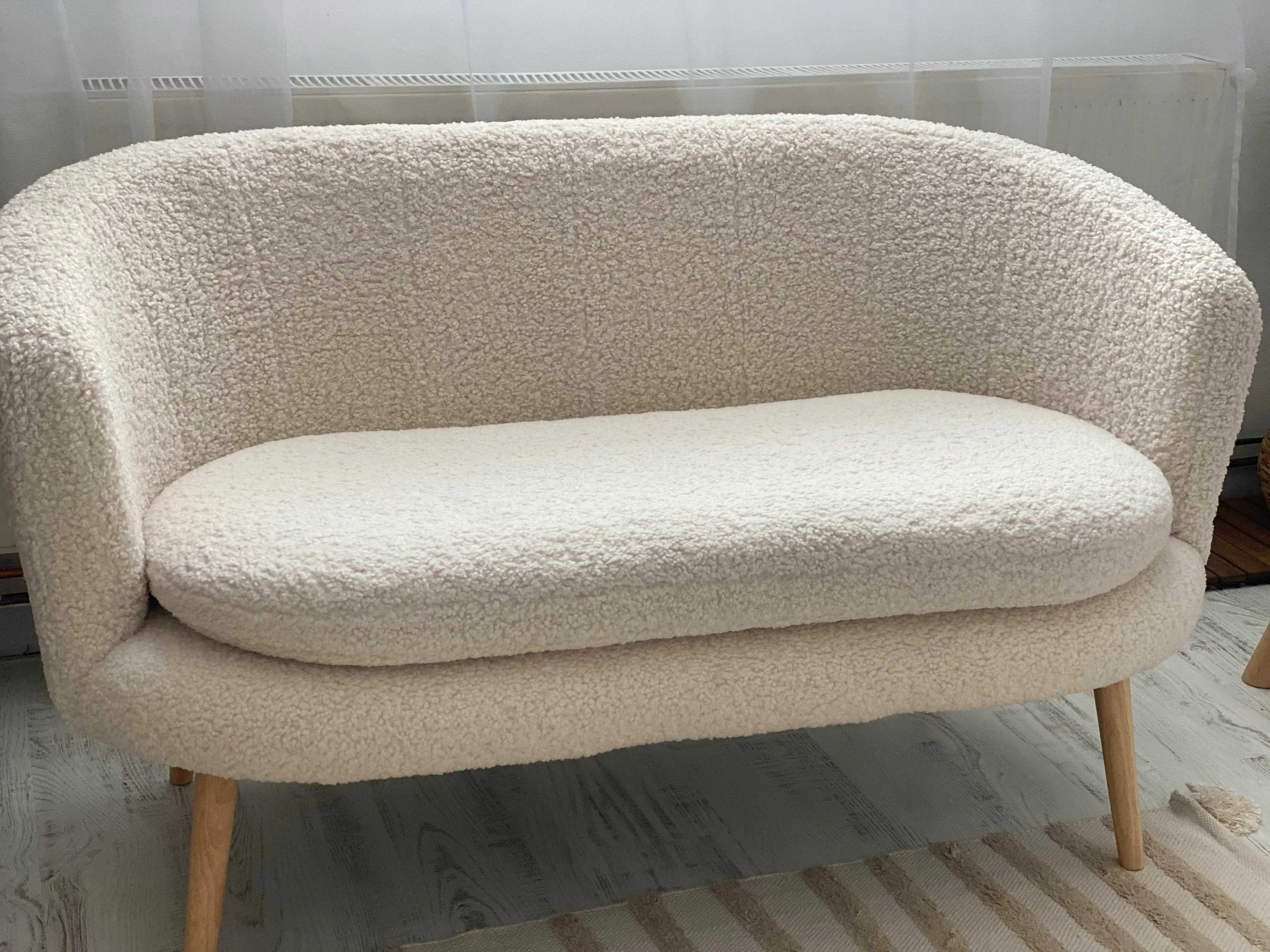 A white couch sitting on top of a wooden floor