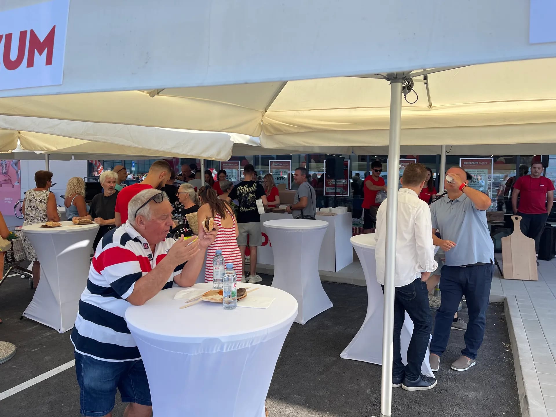 A group of people standing under a tent