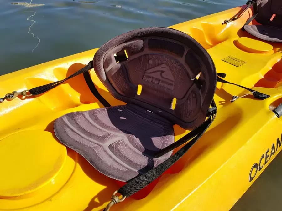 A yellow kayak with a life jacket on it