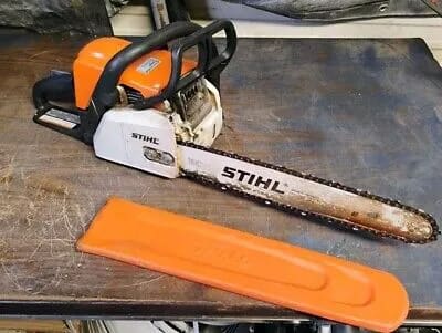A chainsaw sitting on top of a wooden table