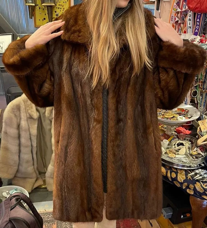 A woman wearing a fur coat in a store