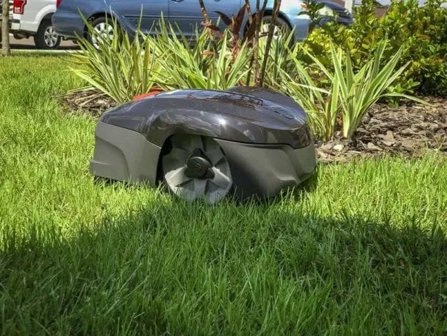 A lawn mower sitting on top of a lush green field