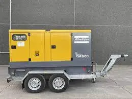 A yellow and gray truck with a yellow generator on the back of it