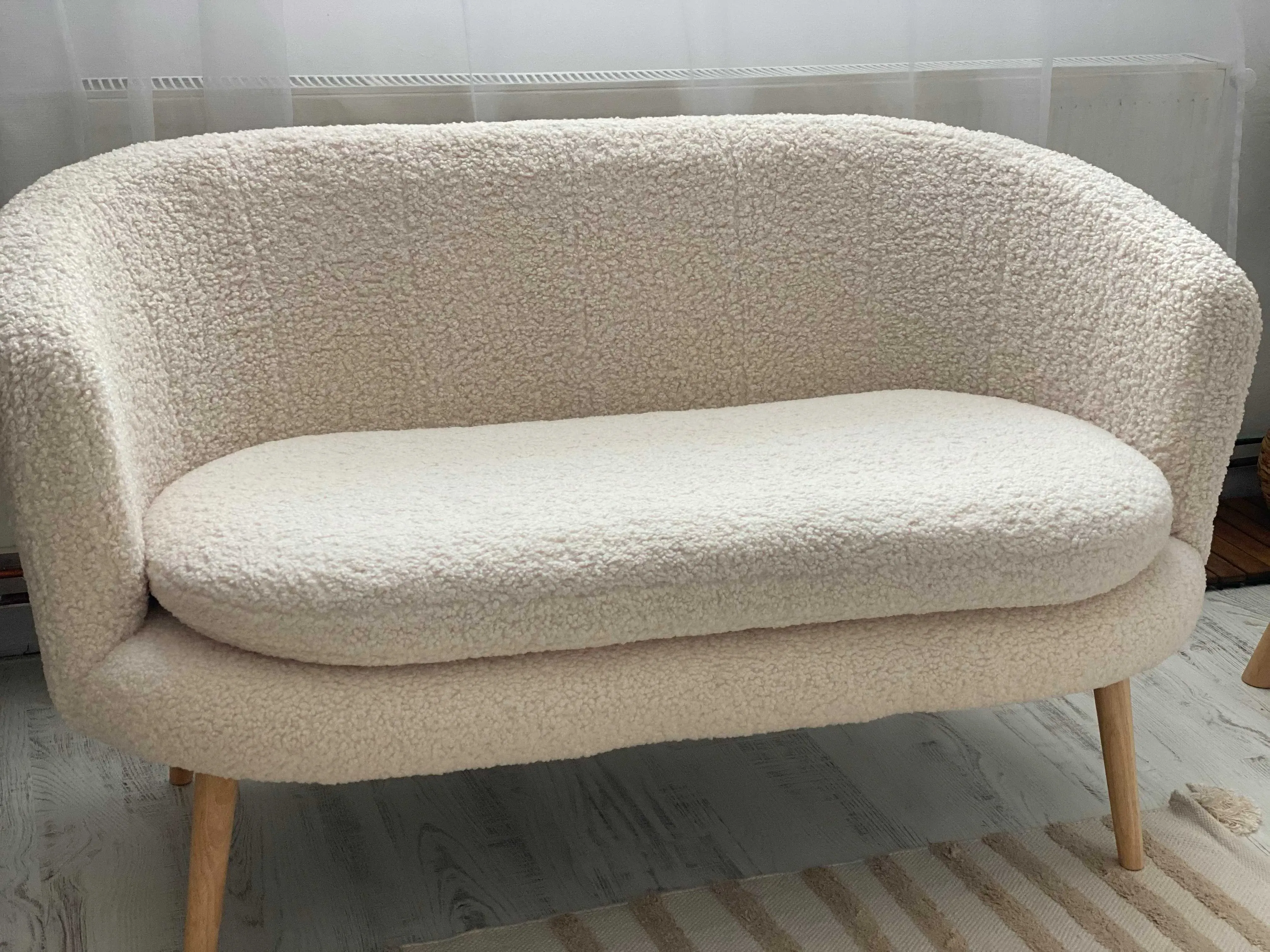 A white couch sitting on top of a wooden floor