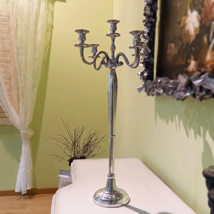 A metal candelabra sitting on top of a white table