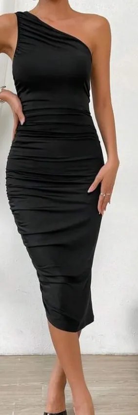 A woman in a black dress posing for a picture