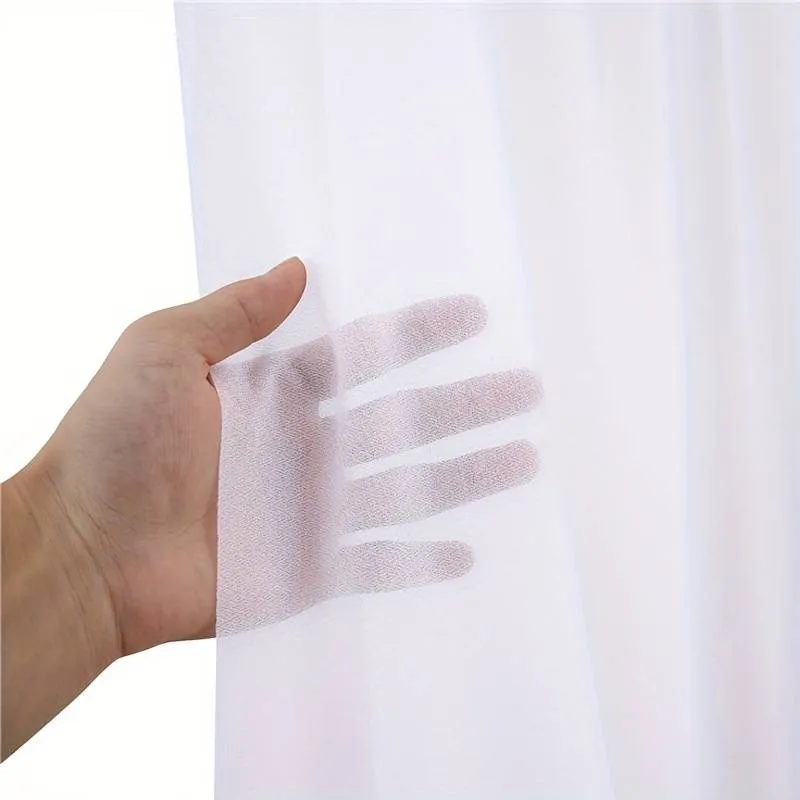 A person holding a curtain with their hand
