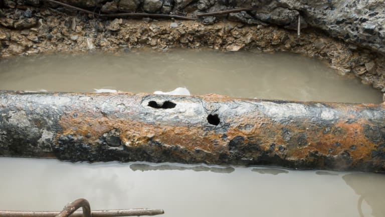 old galvanized pipe leaking under a slab foundation