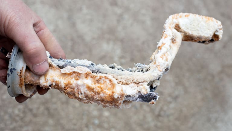 A corroded water heater component.