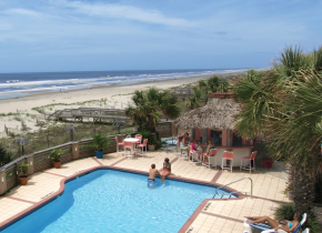 Outdoor pool and beach at The Winds Resort Beach Club.