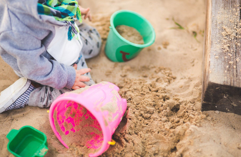 Kid playing in sand at Ocean Trails Resort.