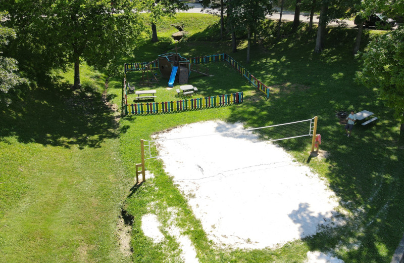 Playground and volleyball court at Lynnhurst Family Resort.